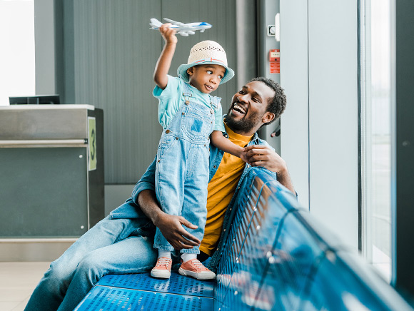 Dad and little girl waiting at airport gate